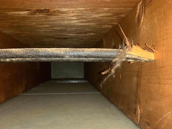 Inside residential ductwork after cleaning. No dust or debris, just clean metal and wood.