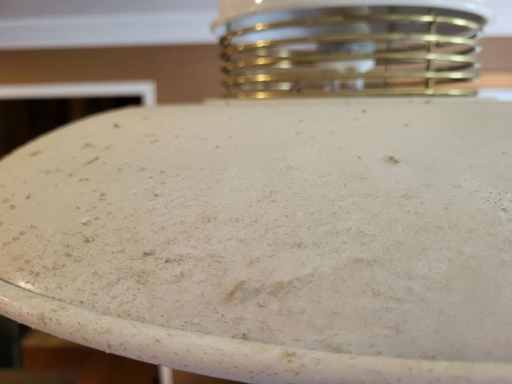 Residential light fixture before being cleaned. Covered with a thick layer of dust.
