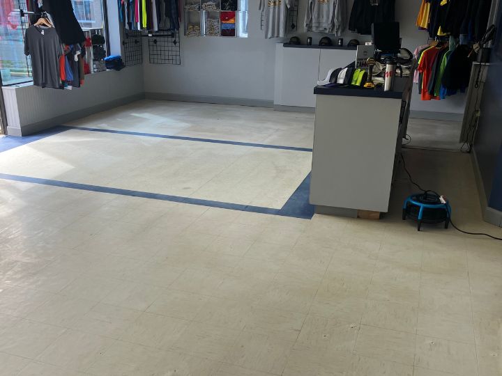 Commercial linoleum floor before being stripped & waxed. Dull and dust covered.
