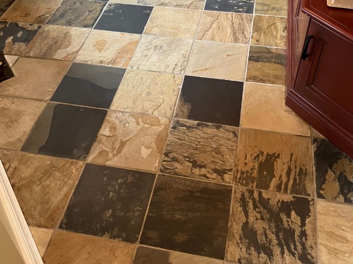 Patterned and textured ceramic tile floor after being cleaned. Free of dirt and grime, grout is restored to bright ivory colour.
