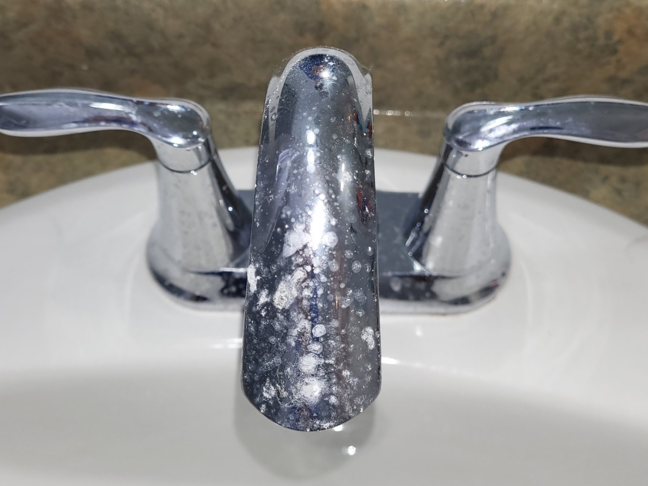 Chrome sink taps and fauce before cleaning. Covered with soap scum, dirt, and scale.